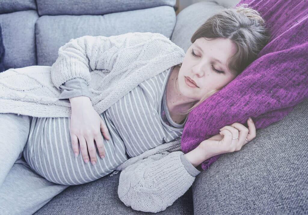 Young pregnant woman sleeping at home