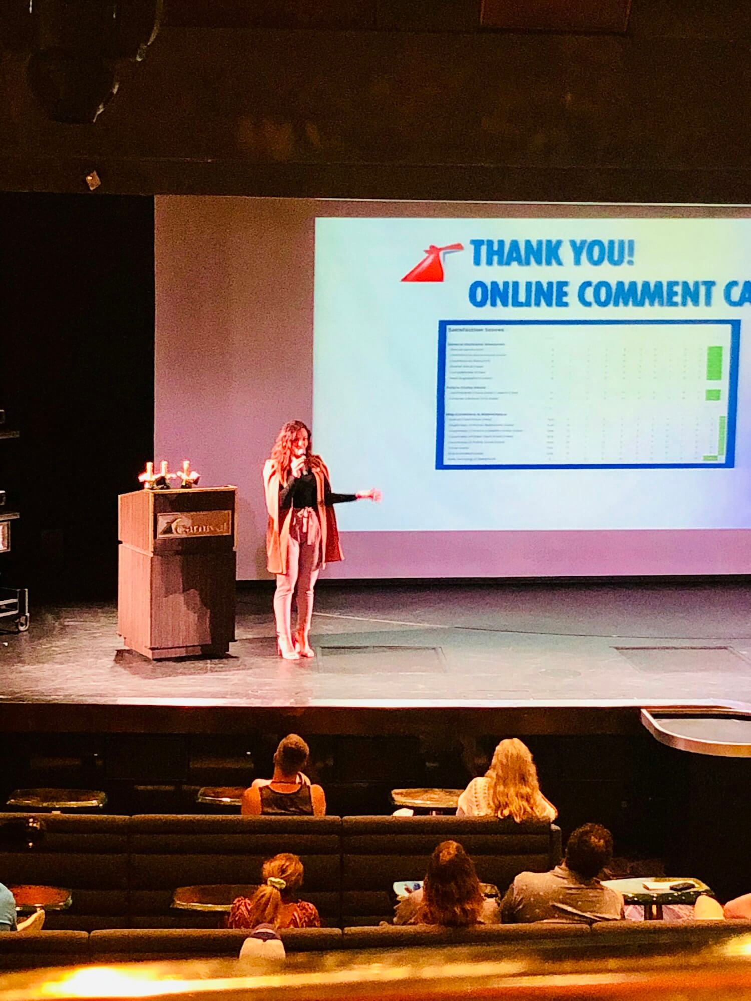 Confident woman on stage public speaking.