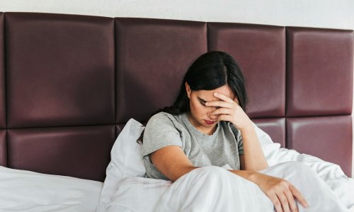 Female lying in bed and having sleeping problems