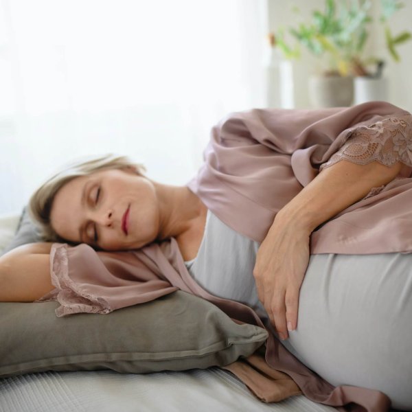 Pregnant woman sleeping and resting in her bed.