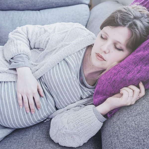 Young pregnant woman sleeping at home